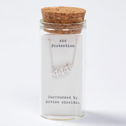 Necklace with '444' symbol in a glass jar labeled 'Protection' on a white background