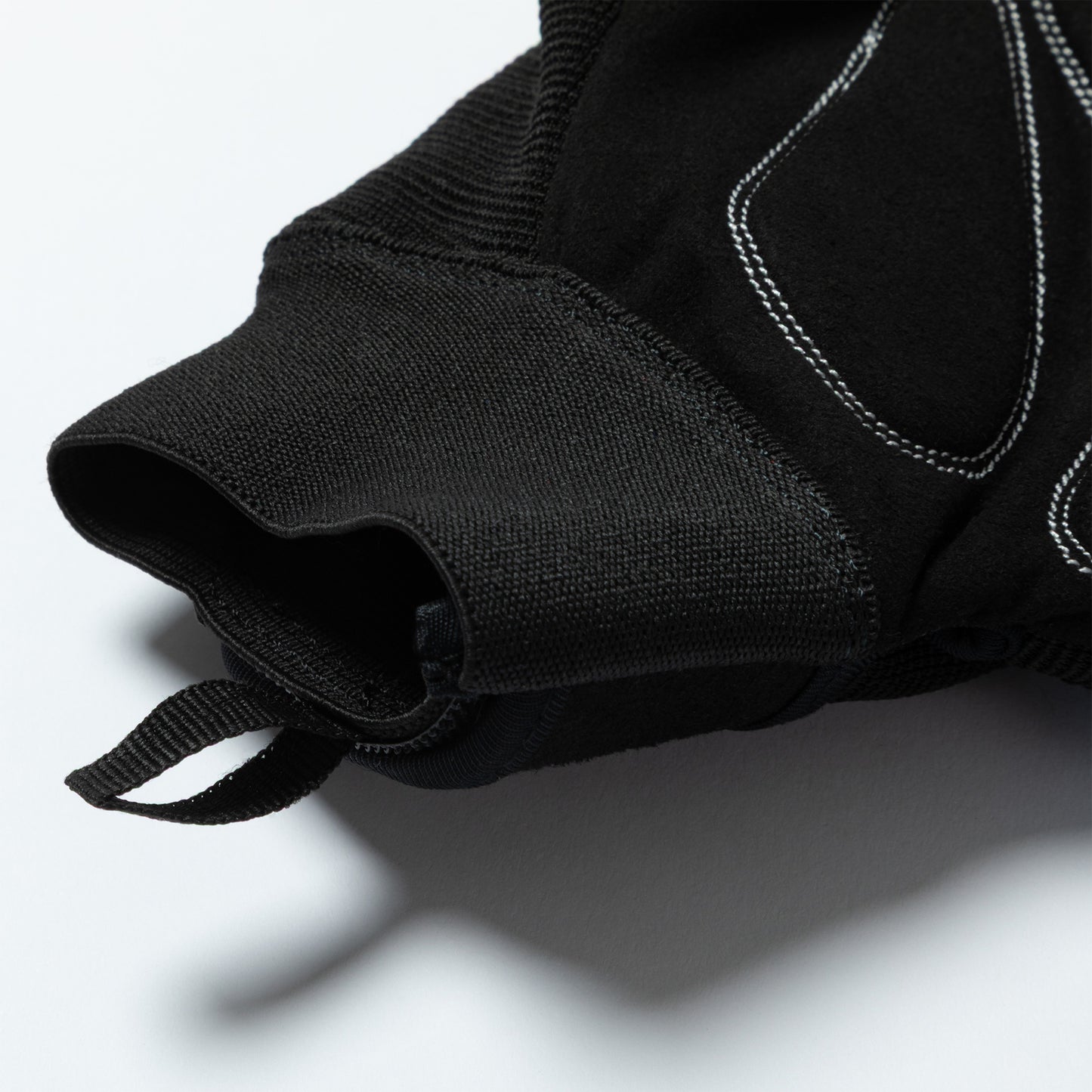 Close-up of a black bite blocker glove with a white background