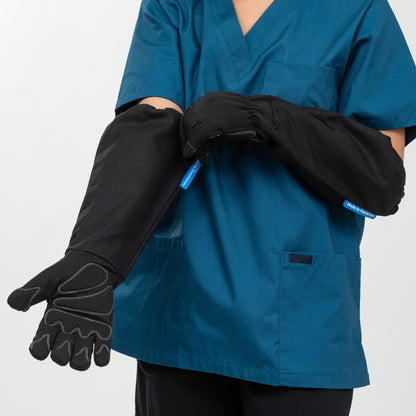 Person wearing blue scrubs with black gloves on a white background