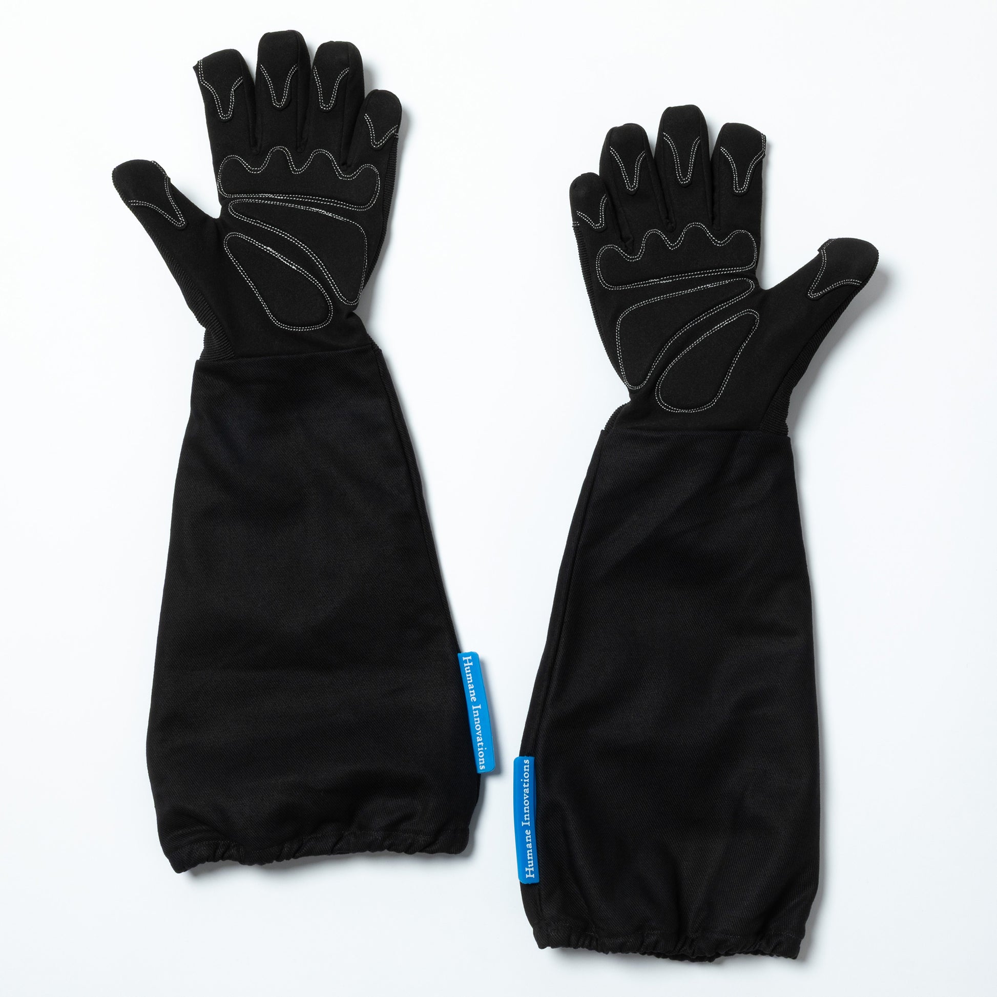 Pair of black gloves with sleeves on a white background