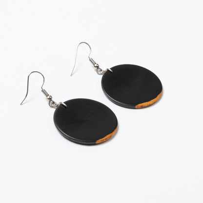 Black circular earrings on a white background
