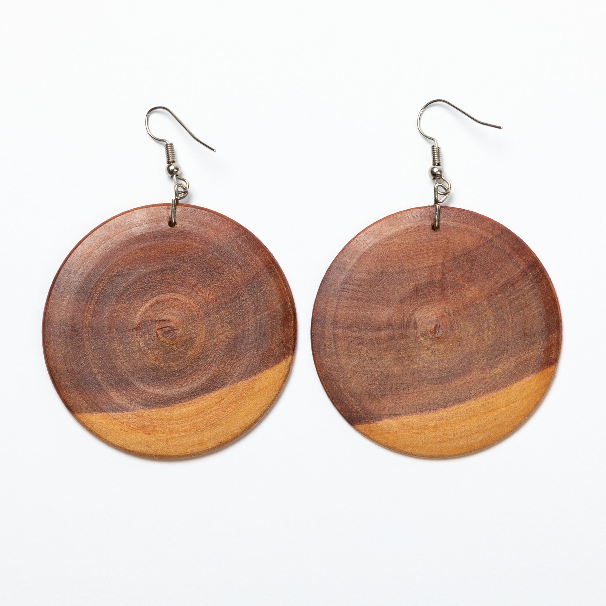 Wooden circular earrings on a white background