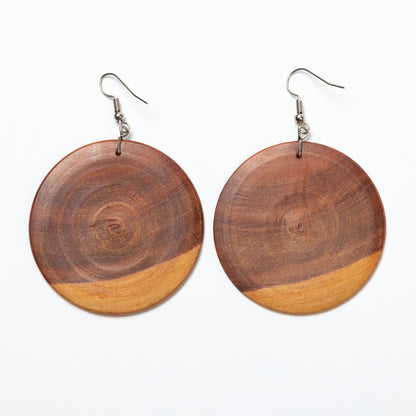 Wooden circular earrings on a white background