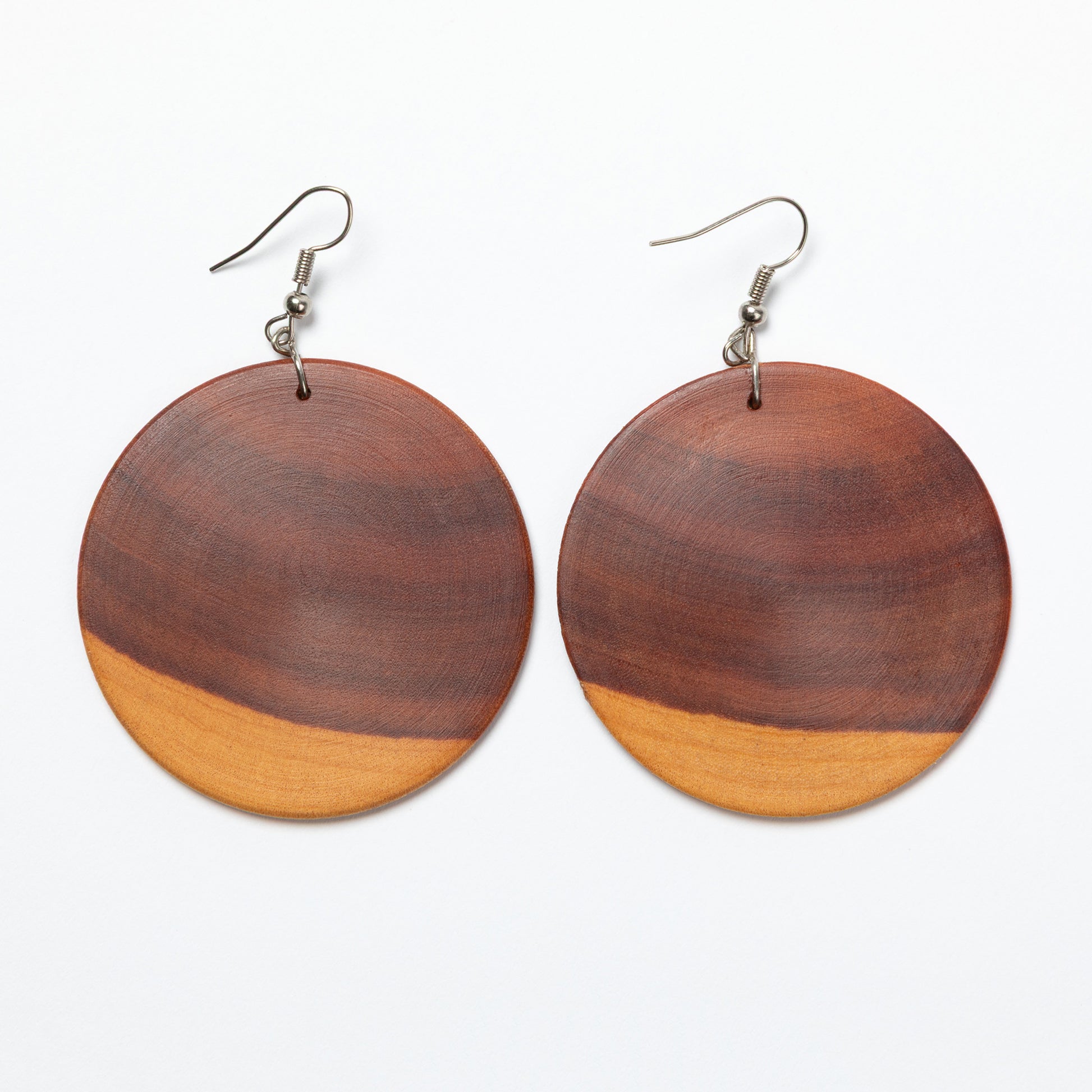 Wooden earrings with two-tone design on a white background
