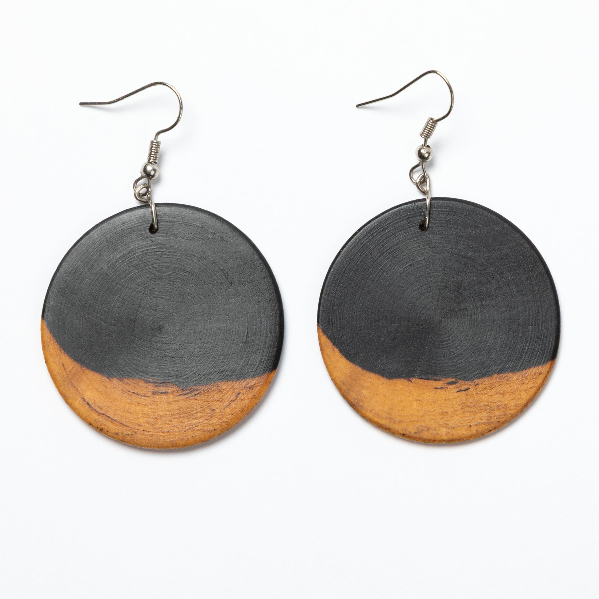 Pair of earrings with black and wood finish on a white background