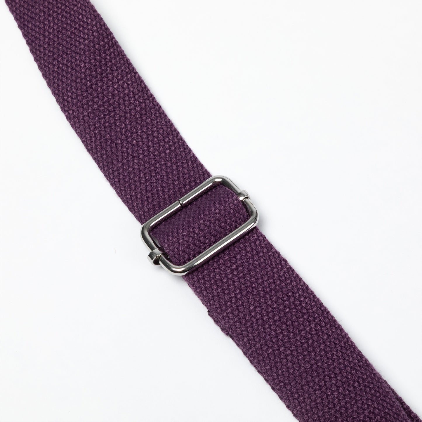 A close-up of a textured purple woven strap with a silver-toned metal buckle, shown diagonally on a plain white background.