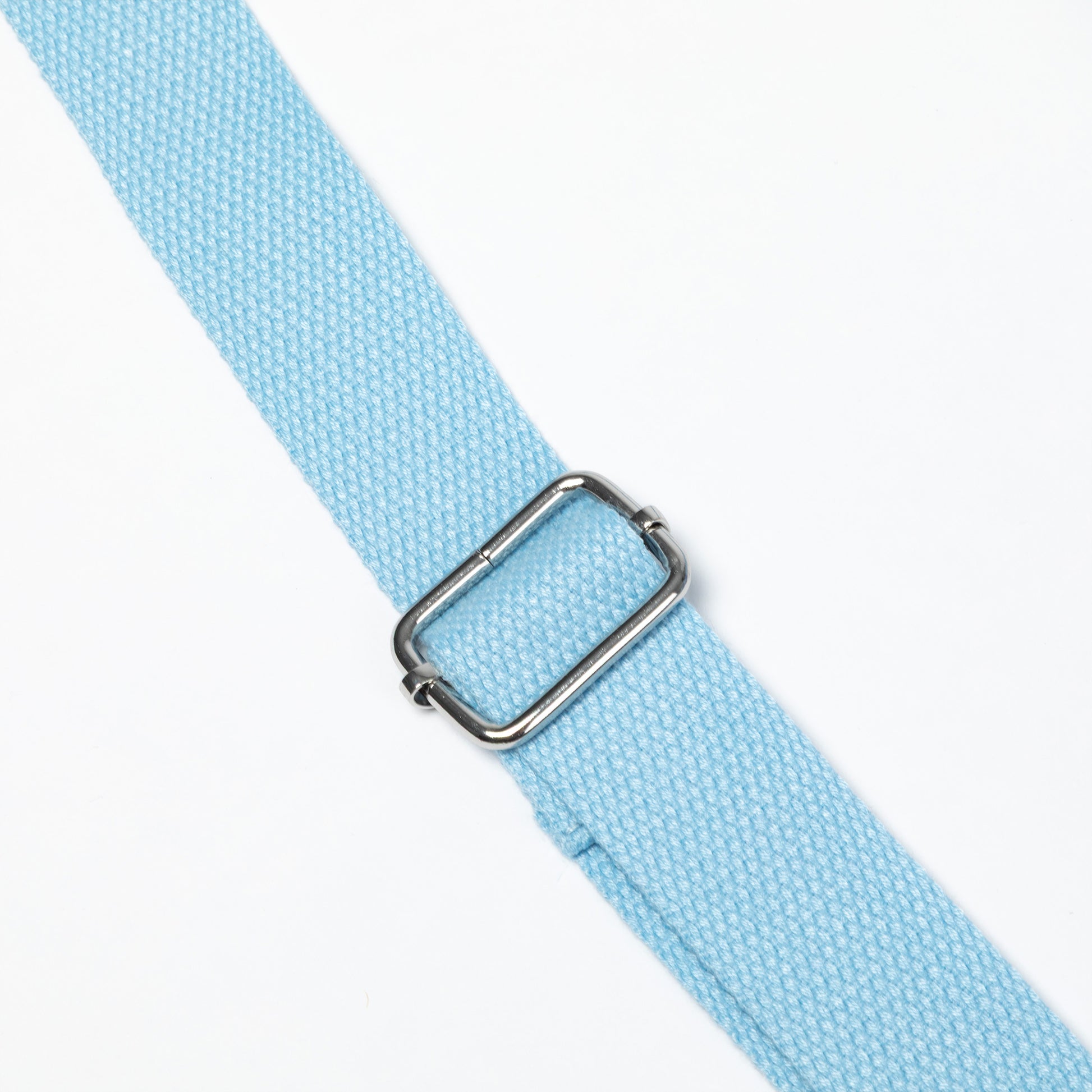 A close-up of a light blue woven strap with a silver metal buckle, shown diagonally on a plain white background.