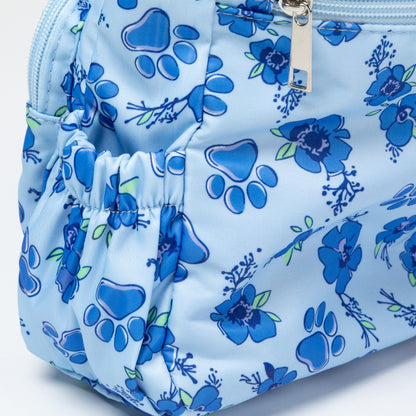 A light blue zippered pouch featuring a blue paw print and floral pattern, with a silver zipper pull.