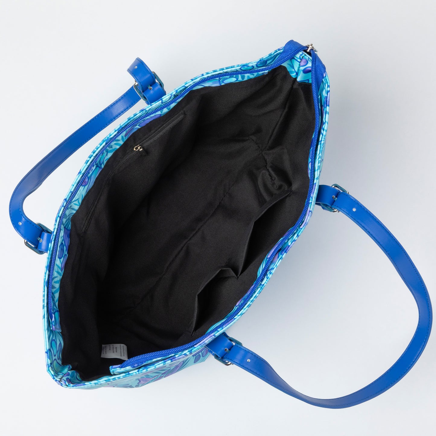 Blue patterned tote bag with a black interior on a white background