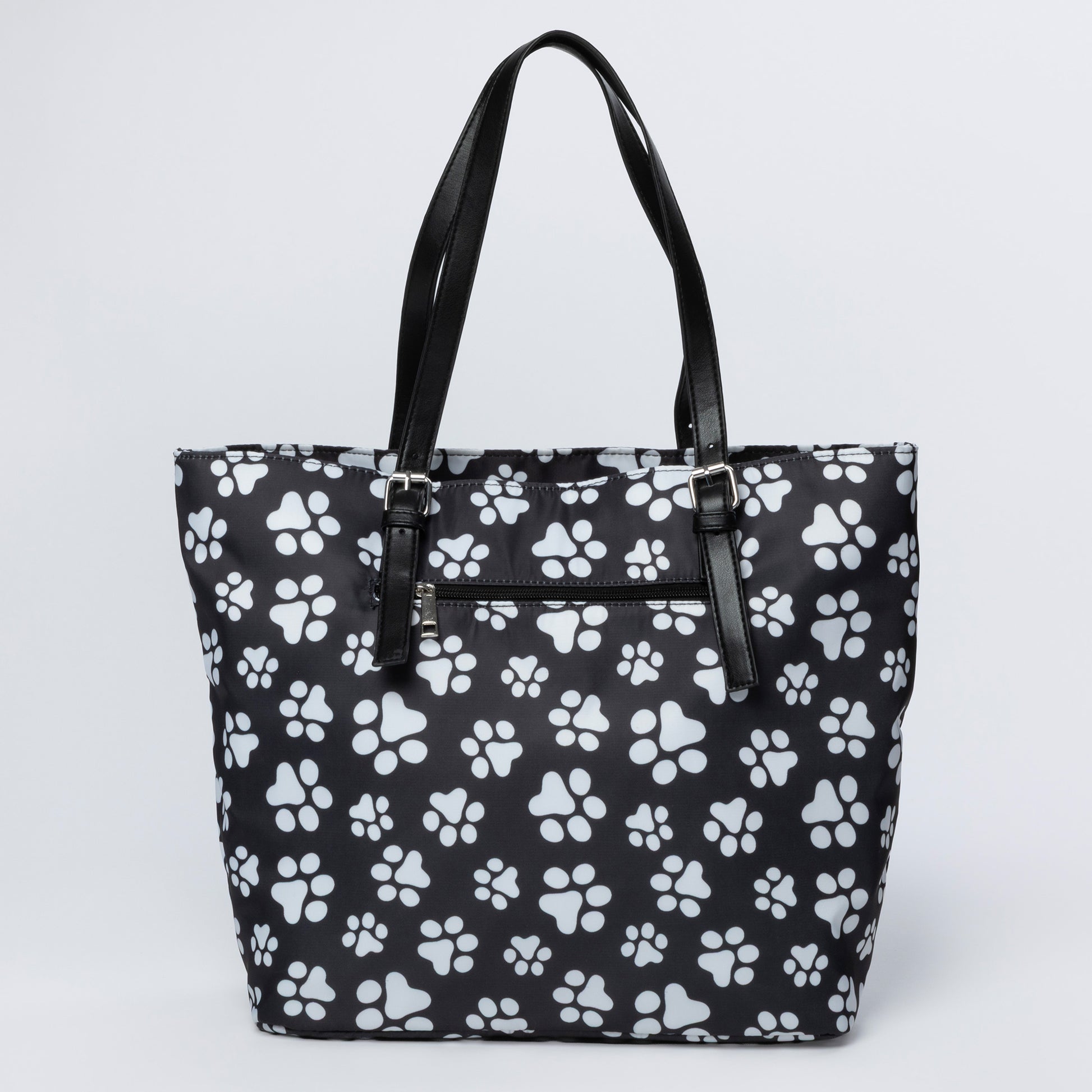 Black tote bag with white paw print pattern on a light gray background