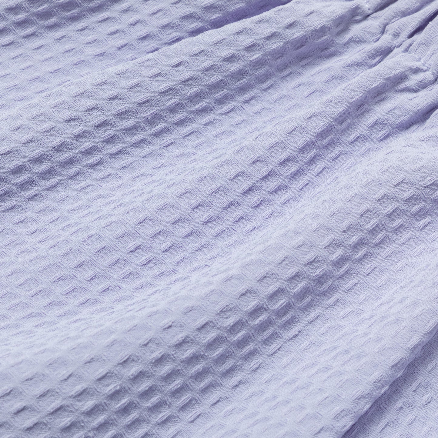 Close-up of textured waffle weave purple fabric