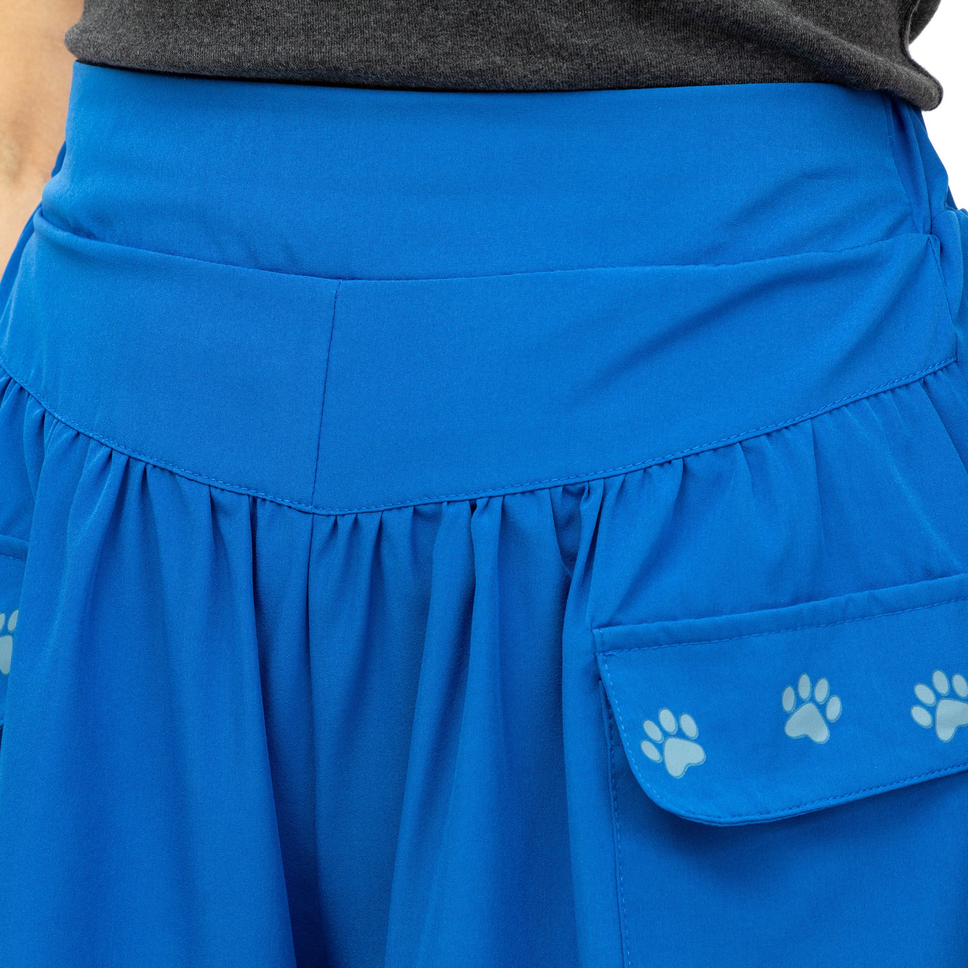 Blue skirt with paw print pocket on a plain background