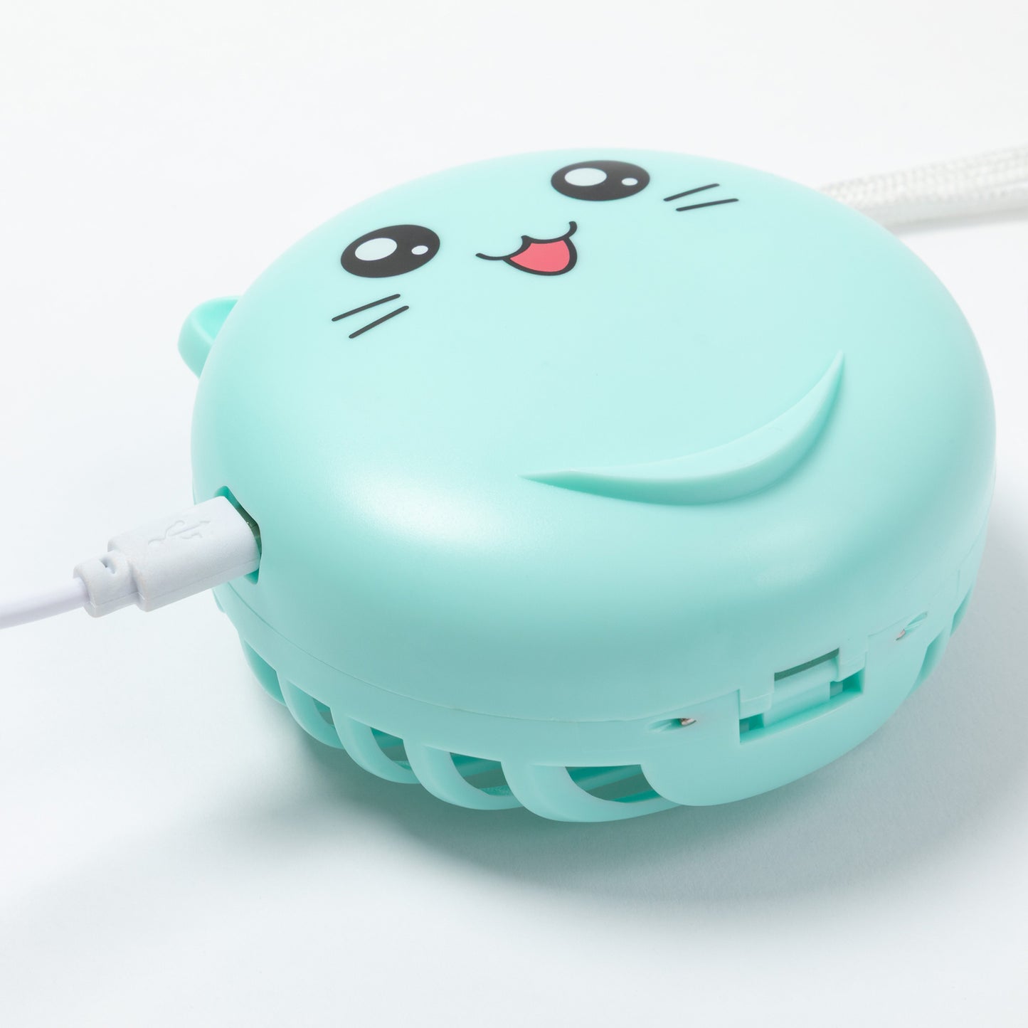 A mint green portable mini fan with a cute cartoon cat face printed on top, shown with its white power cable on a clean white background.