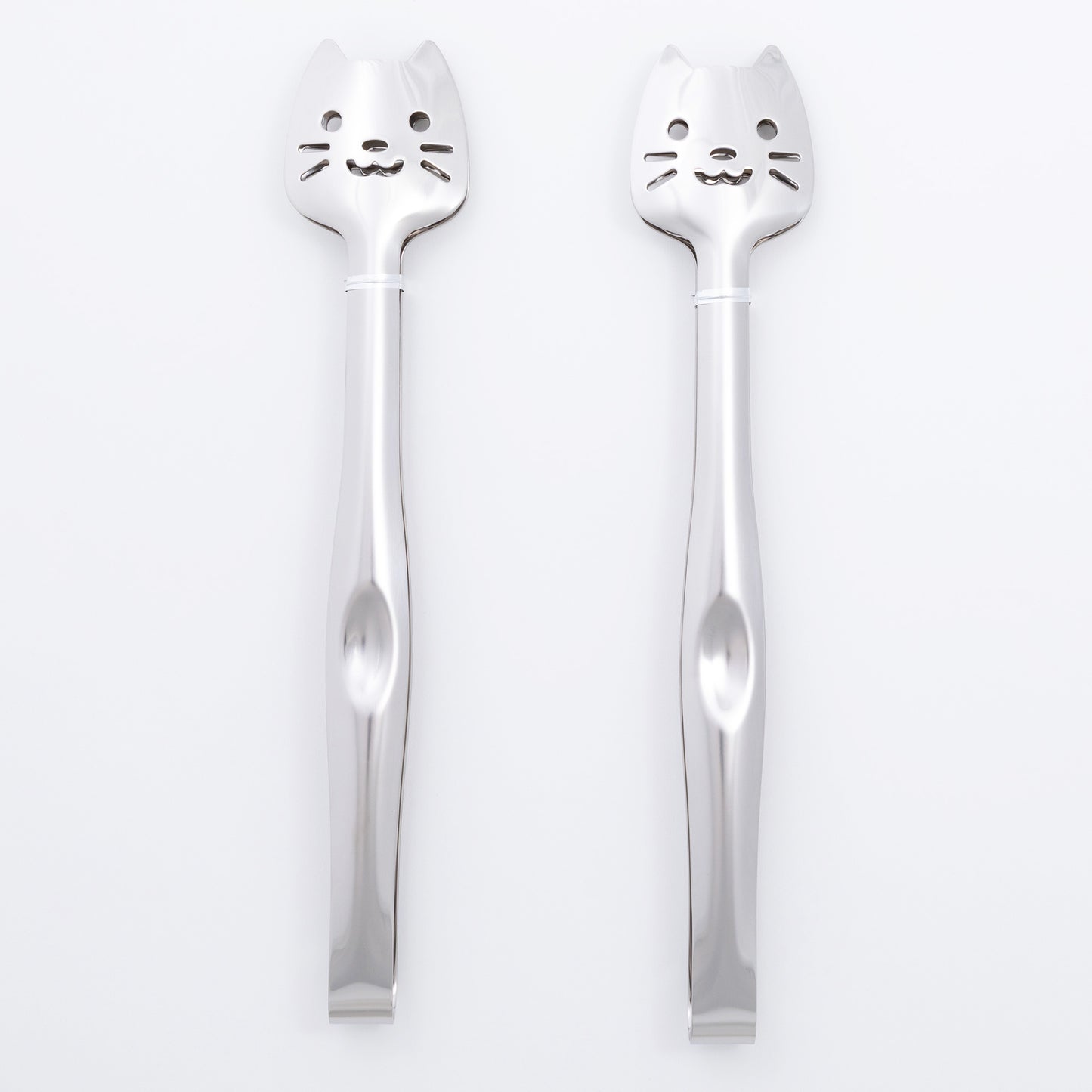Two silver spoons with cat faces on a white background