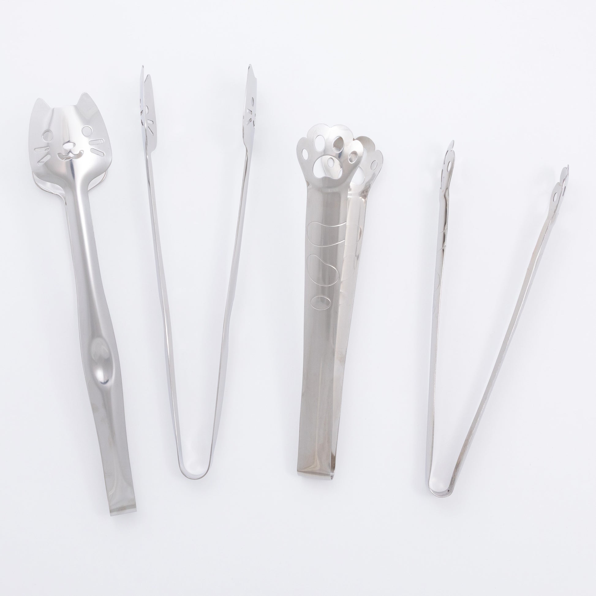 Set of silver kitchen tongs on a white background