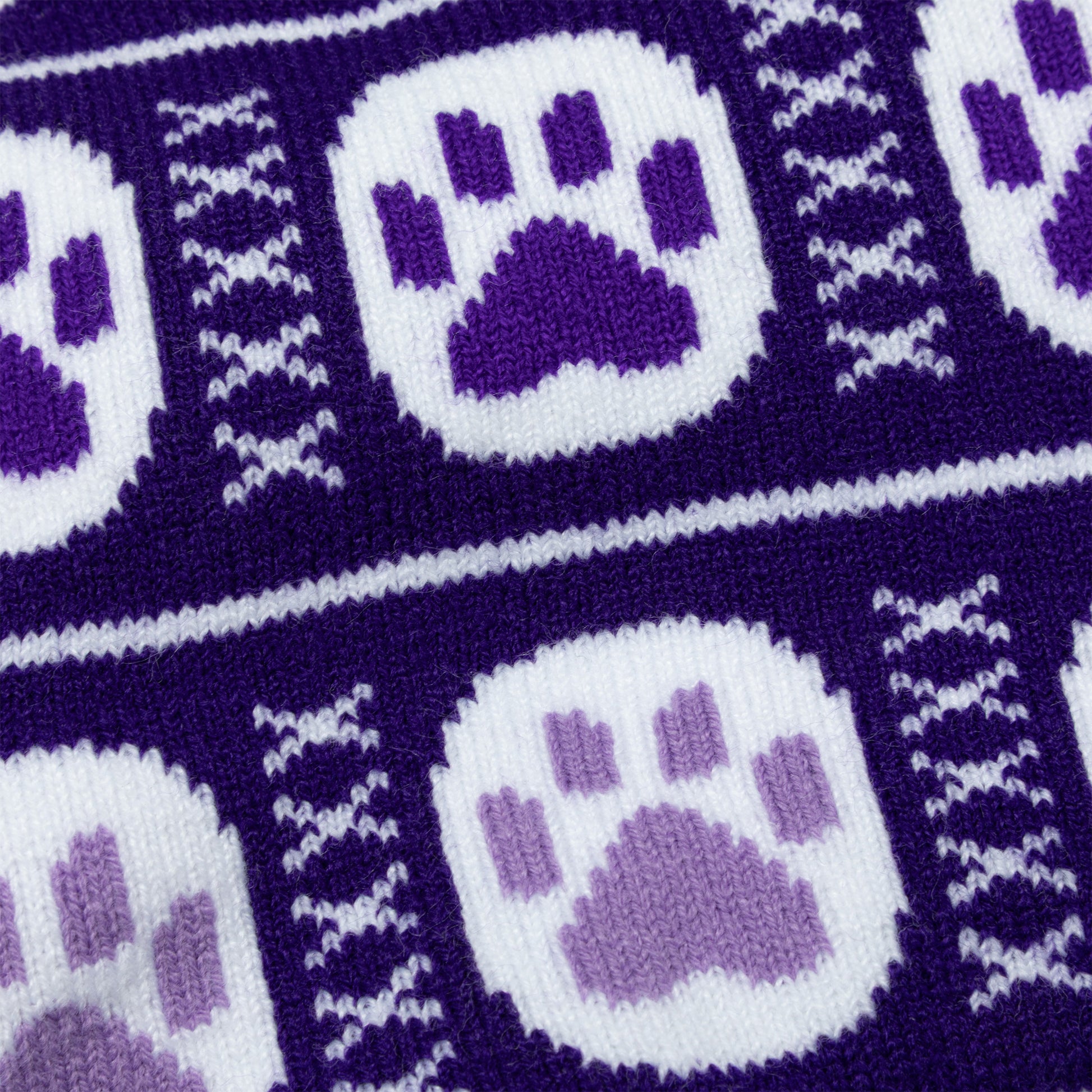 Close-up of purple and white fabric with paw print pattern