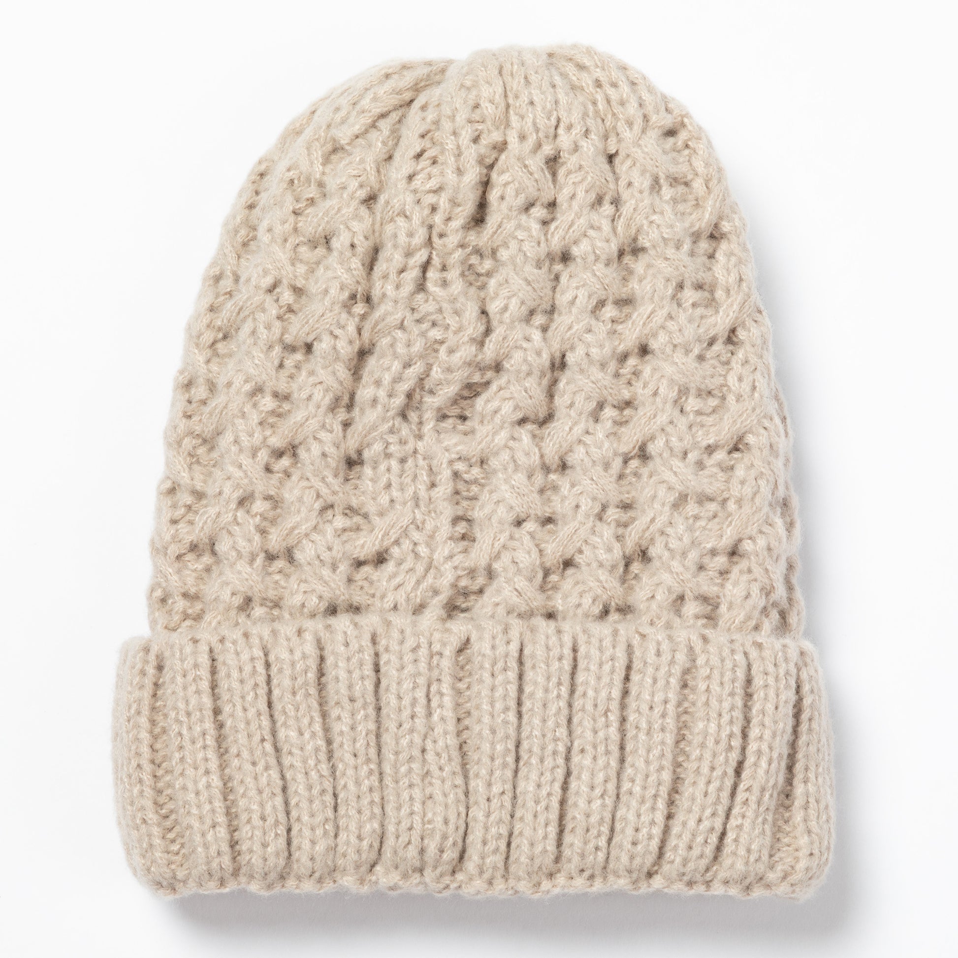 A beige cable-knit beanie hat with a ribbed cuff, shown flat against a white background.