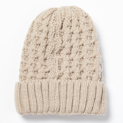 A beige cable-knit beanie hat with a ribbed cuff, shown flat against a white background.