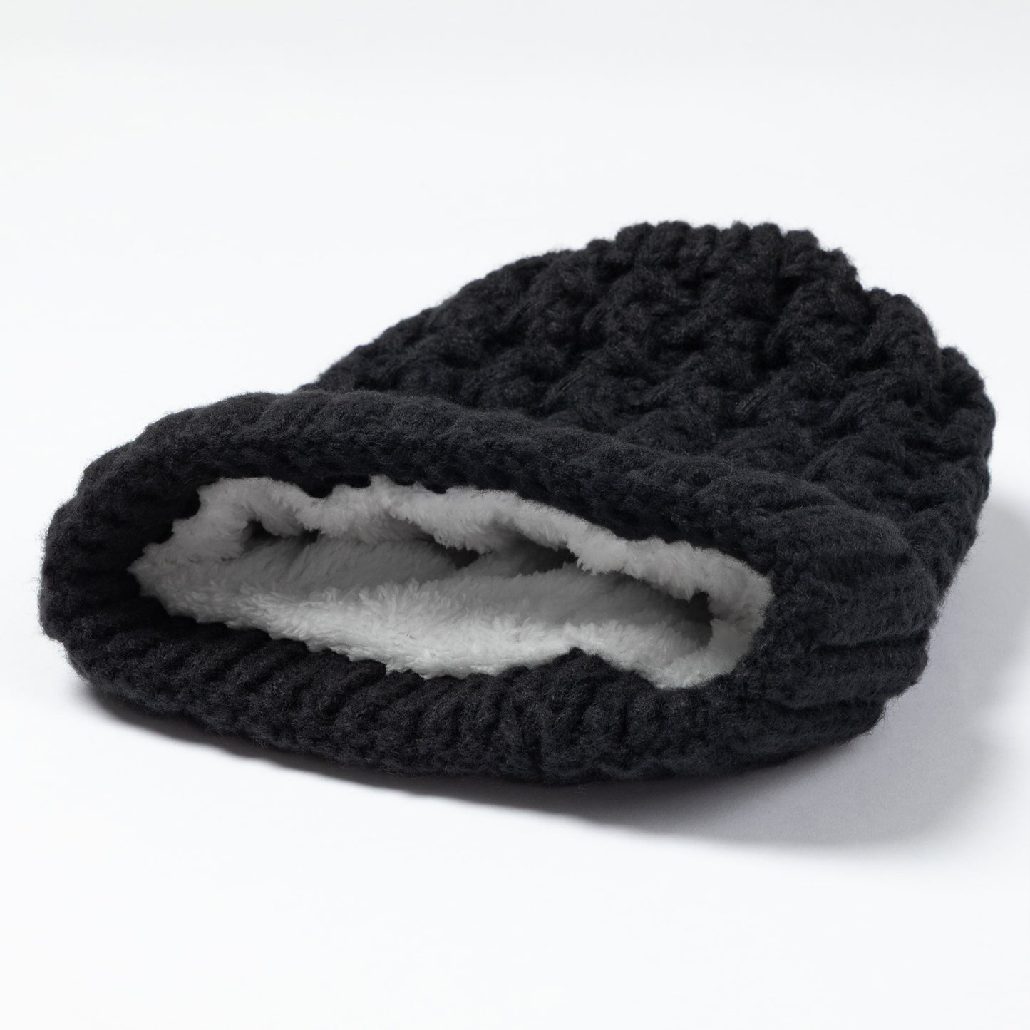 A black textured knit beanie hat with a soft white fleece lining, shown on a clean white background.