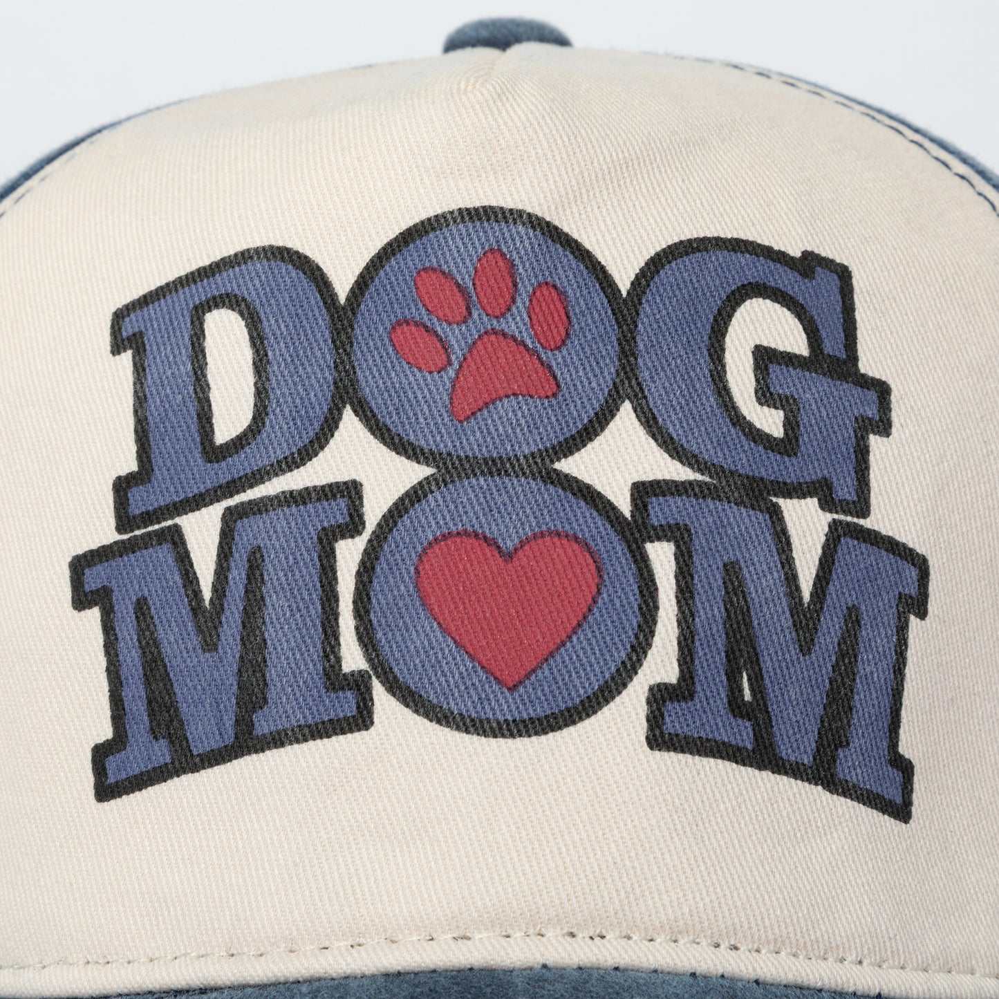Cap with 'DOG MOM' text and paw prints on a white background