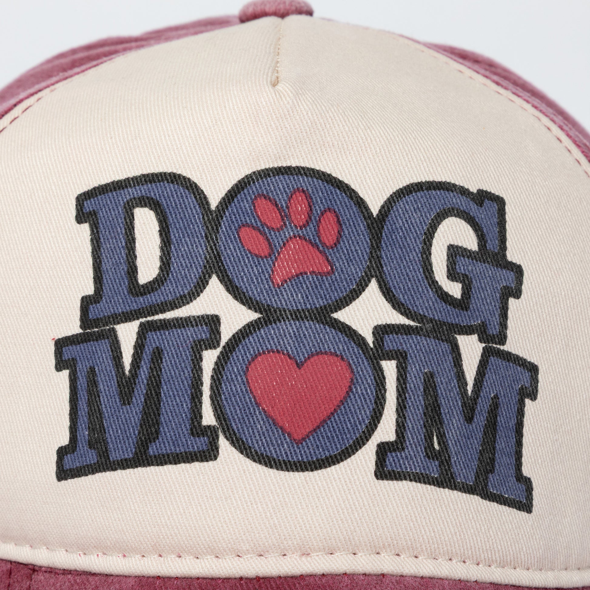Cap with 'DOG MOM' text and paw print design on a white background