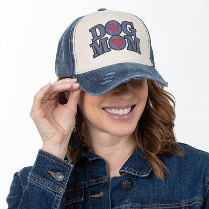 Woman wearing a cap with 'DOG MOM' text on a white background