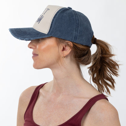 Woman wearing a blue and beige cap on a white background