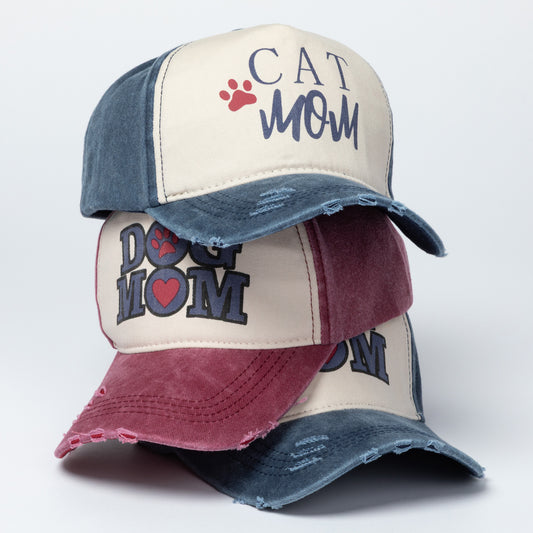 Three baseball caps with 'Cat Mom' and 'Dog Mom' text on a white background