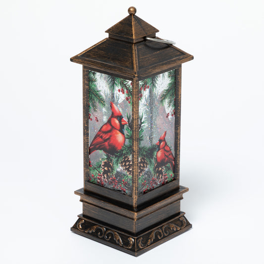 Decorative lantern with cardinals and winter scene on a white background