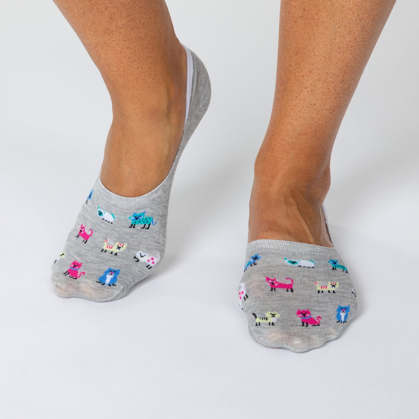 Gray socks with animal patterns worn by a person on a white background
