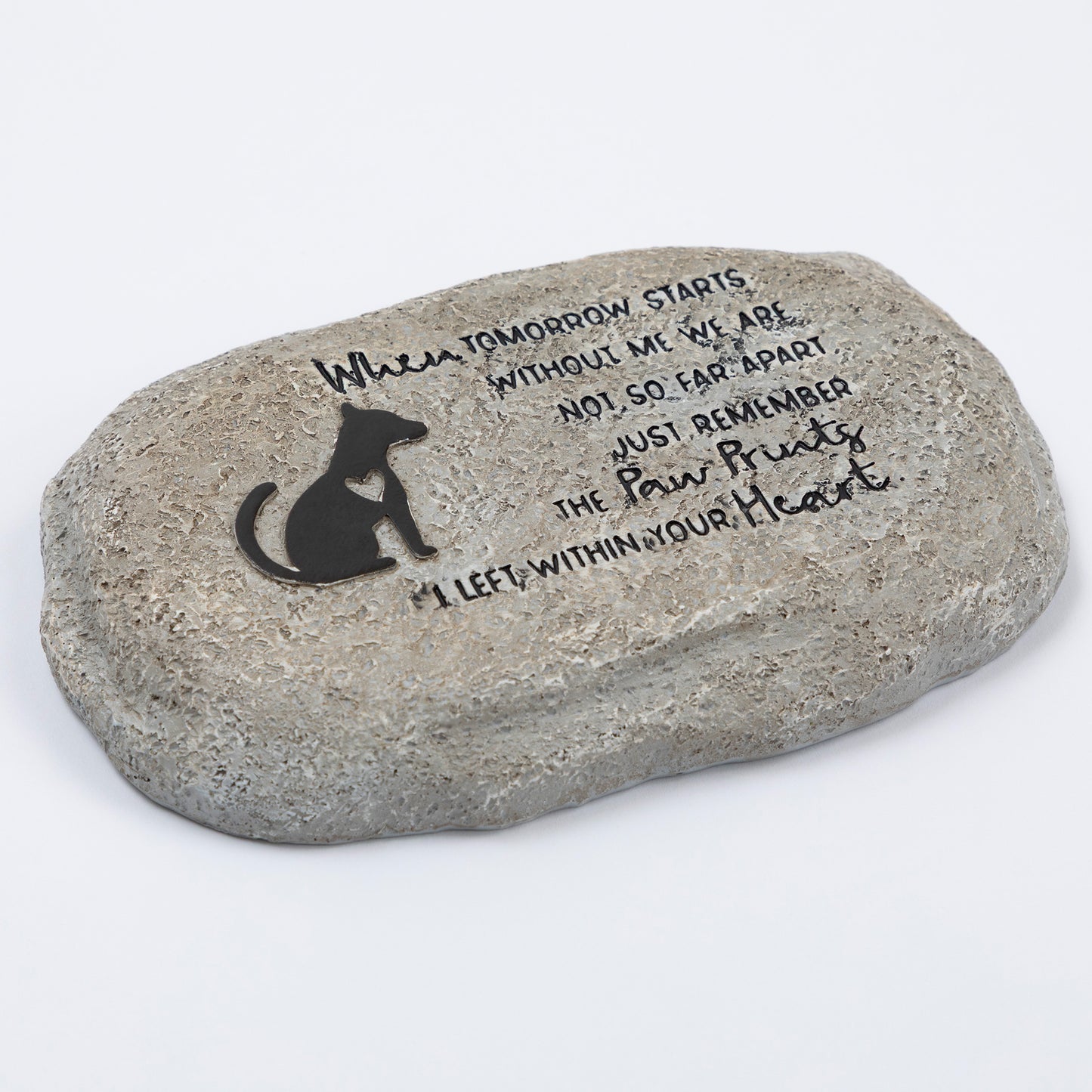 Decorative stone with engraved text and a silhouette of a dog on a white background