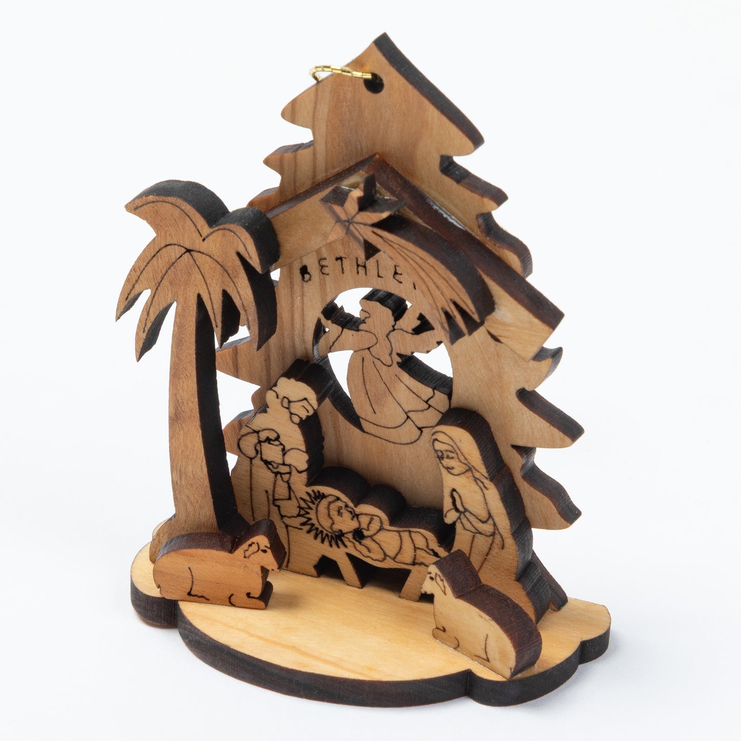 A wooden nativity scene ornament featuring a stable, palm tree, baby Jesus, Mary, Joseph, animals, and the word 'BETHLEHEM' engraved on the roof, shown on a plain white background.