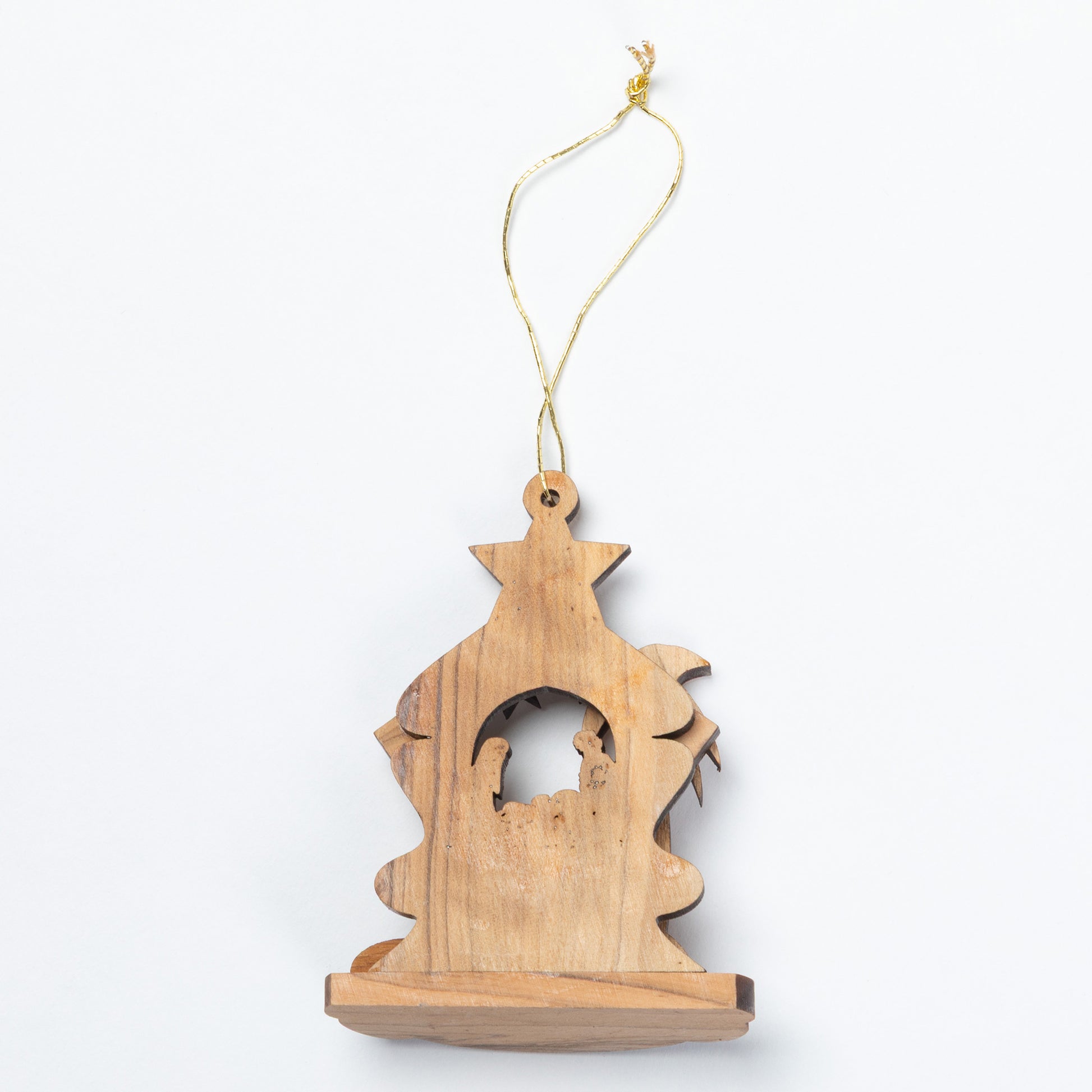 The back of a small handcrafted wooden nativity ornament with a star-shaped top and a gold hanging string, shown against a plain white background.