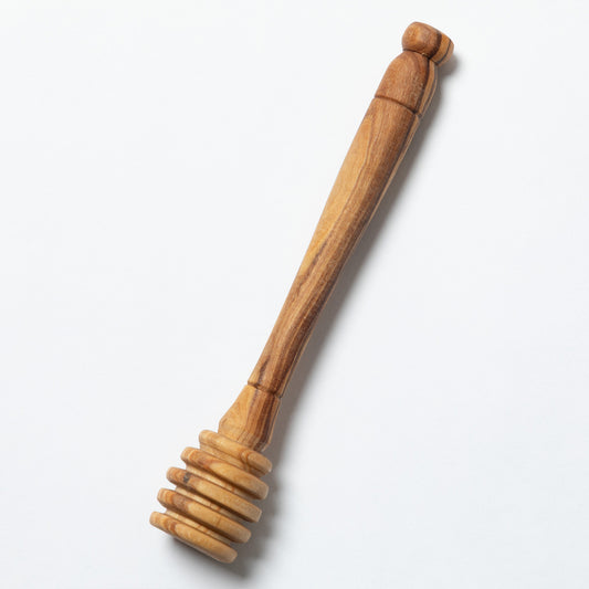 A handmade wooden honey dipper shown against a plain white background.
