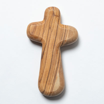 A handcrafted wooden cross with a polished olive wood grain pattern, shown on a clean white background.