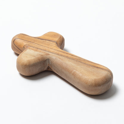 A handcrafted wooden cross with a polished finish, showcasing natural wood grain patterns, photographed on a clean white background.