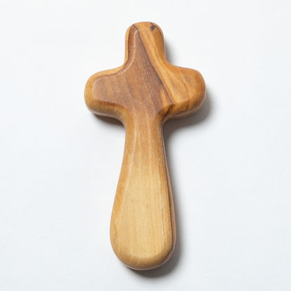 A handcrafted wooden cross with a natural olive wood grain pattern, shown on a white background.