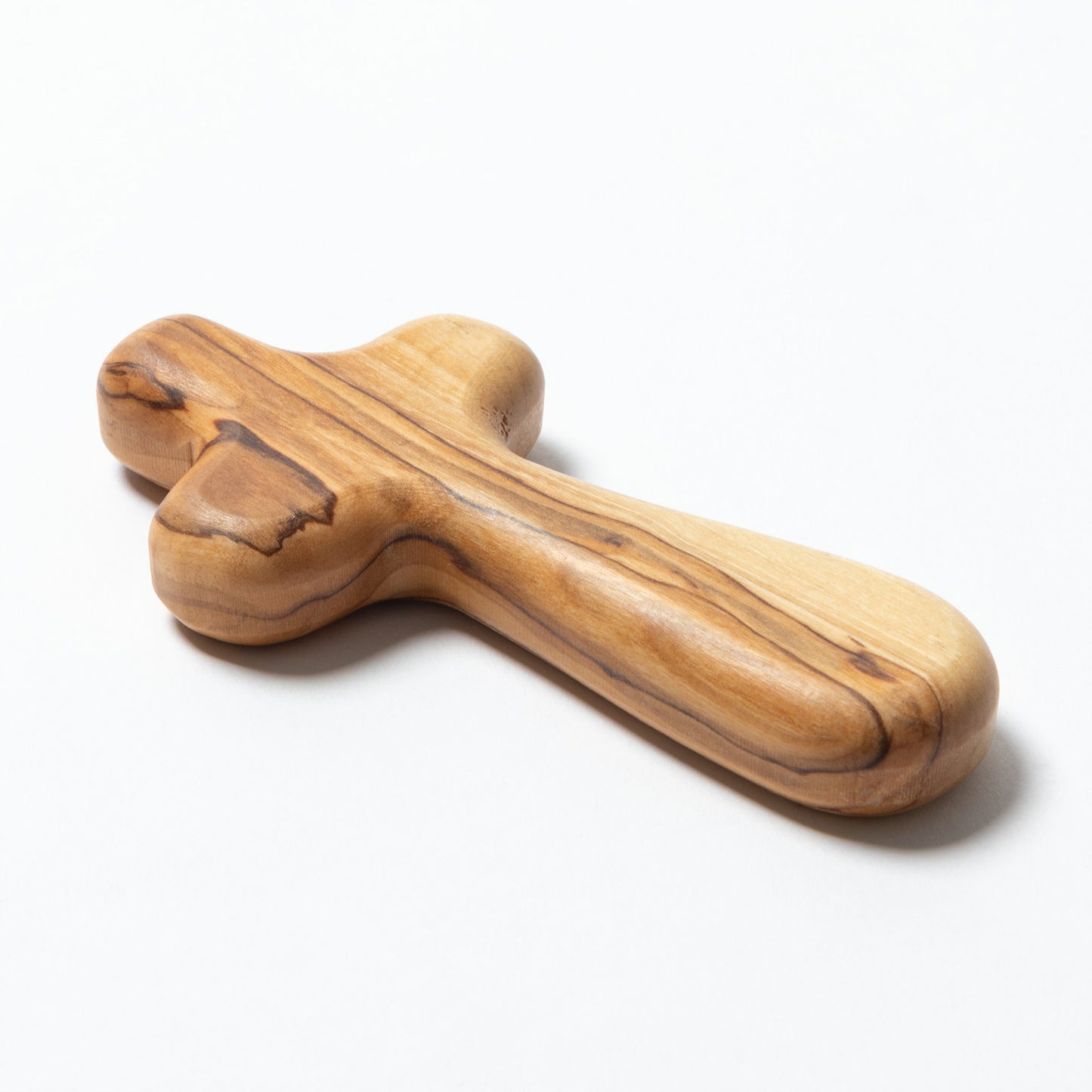 A handcrafted wooden cross with a natural olive wood grain pattern, shown on a white background.