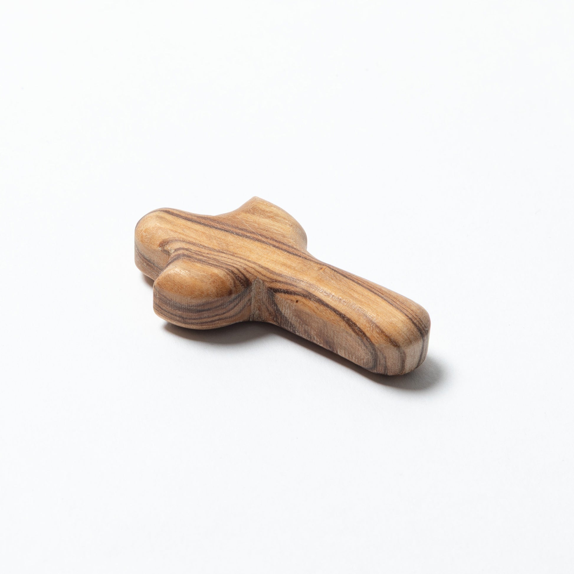 A small handcrafted wooden cross with a natural striped grain pattern, photographed on a white background.