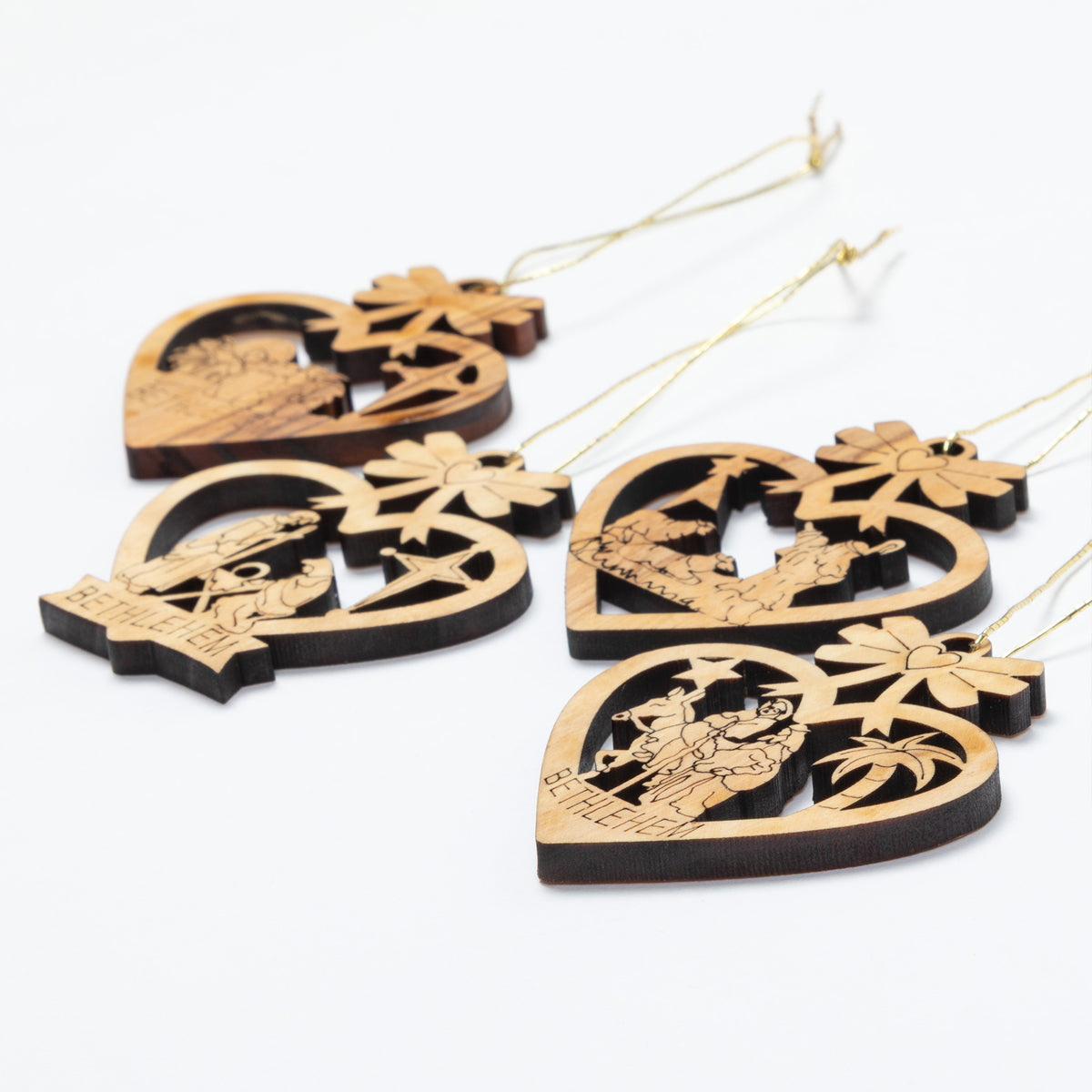 Four wooden hanging ornaments shaped like hearts, each with a different nativity scene cutout and the word 'BETHLEHEM' at the bottom, shown on a plain white background.