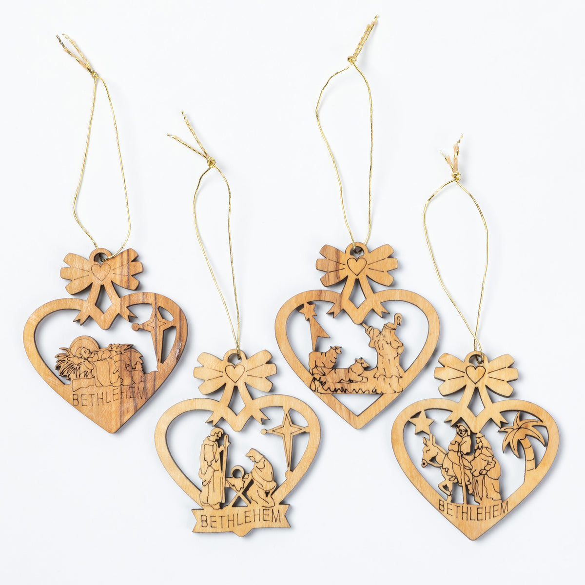 Four wooden hanging ornaments shaped like hearts, each with a different nativity scene cutout and the word 'BETHLEHEM' at the bottom, shown on a plain white background.