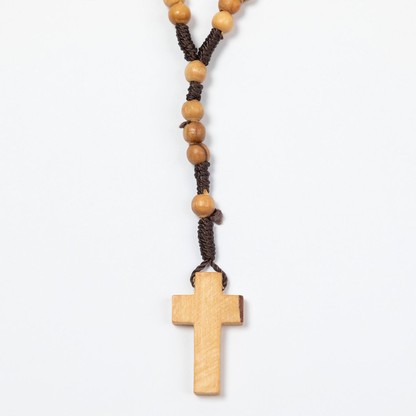 Wooden rosary with cross on a white background