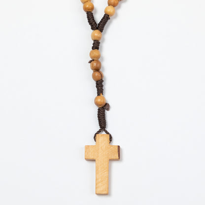 Wooden rosary with cross on a white background