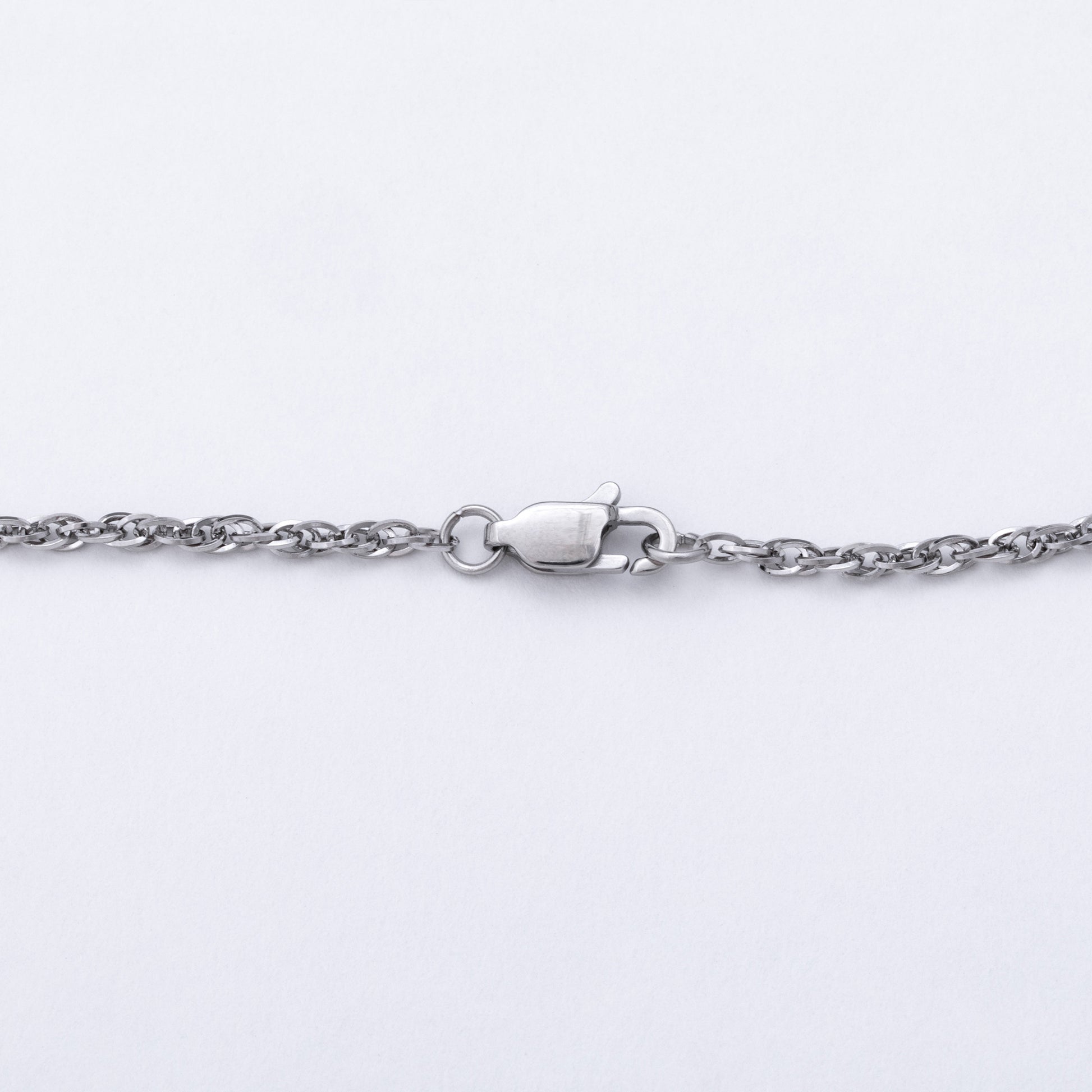 A close-up of a silver-toned metal chain necklace with a lobster clasp, shown against a plain white background.