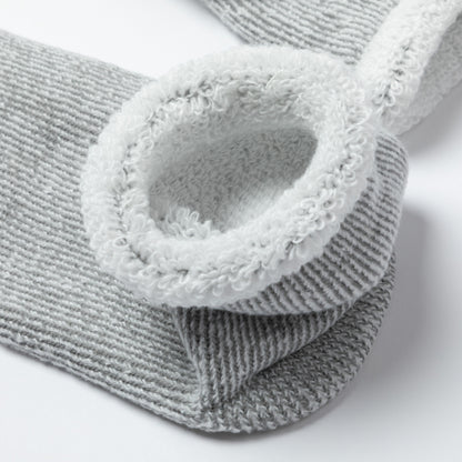 Gray textured socks with fuzzy trim on a white background