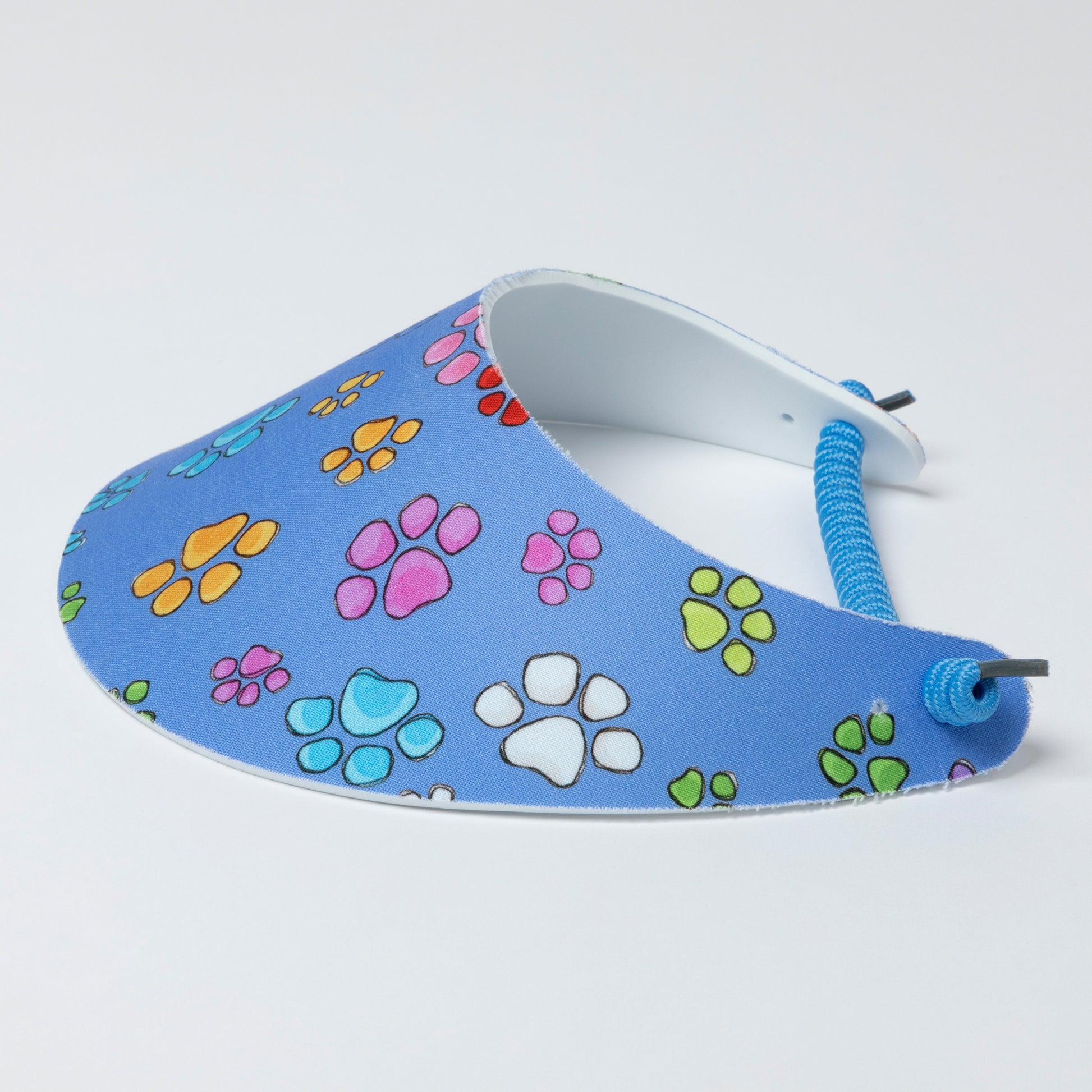 Blue foam visor with colorful paw prints on a white background