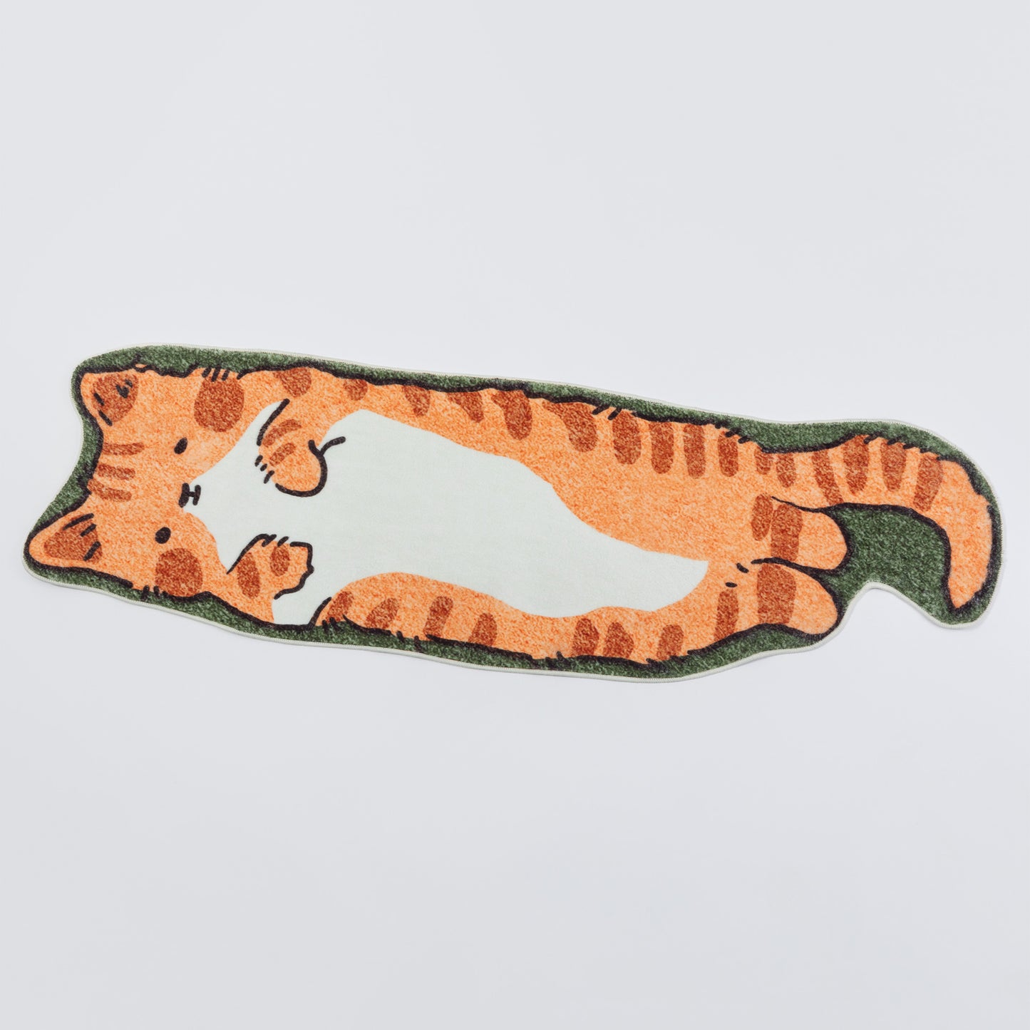 An orange tabby cat-shaped rug with a white belly and green border, shown on a light gray background.