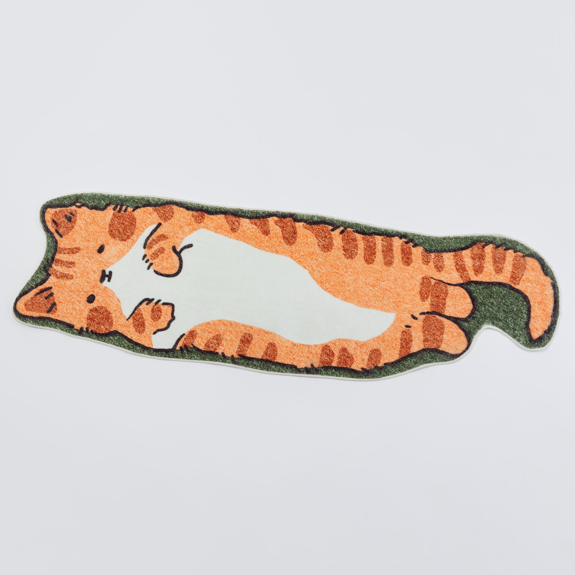 An orange tabby cat-shaped rug with a white belly and green border, shown on a light gray background.