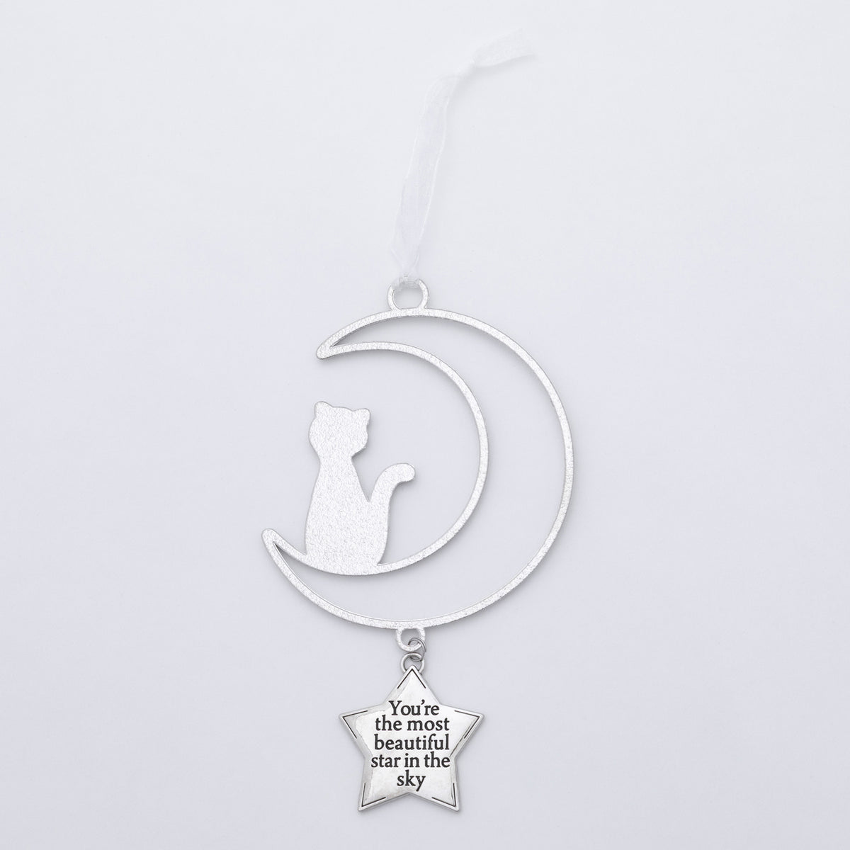 A silver-toned metal hanging ornament featuring a crescent moon silhouette with a seated cat cutout and a dangling star charm that reads, 'You're the most beautiful star in the sky.'.