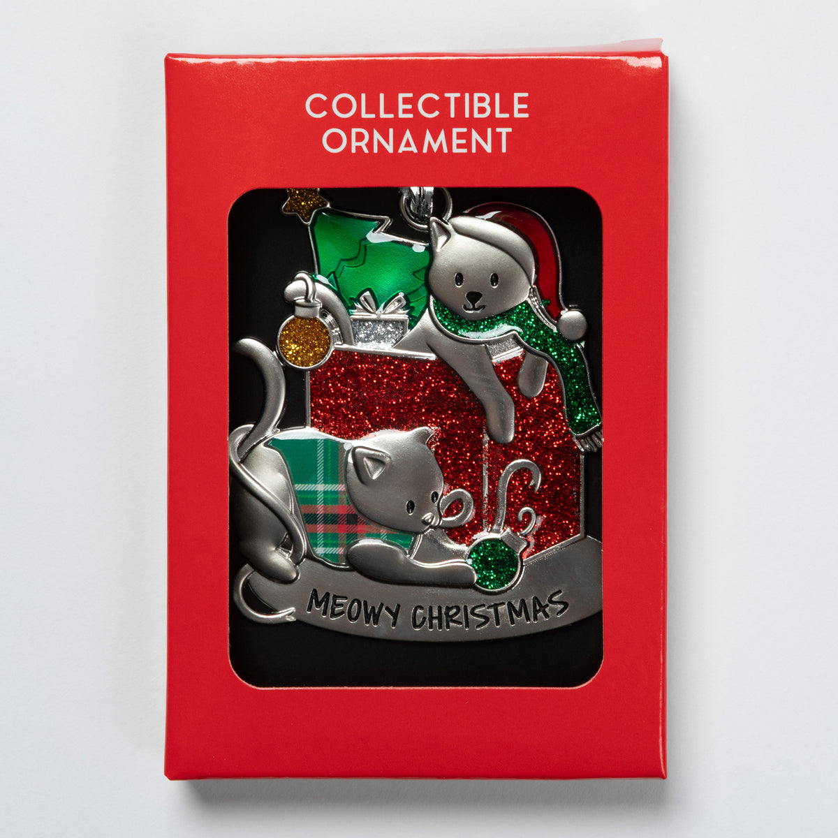A collectible ornament in its red retail packaging, featuring two silver-toned cats with green and red holiday accents and the text 'MEOWY CHRISTMAS' on a black window card.
